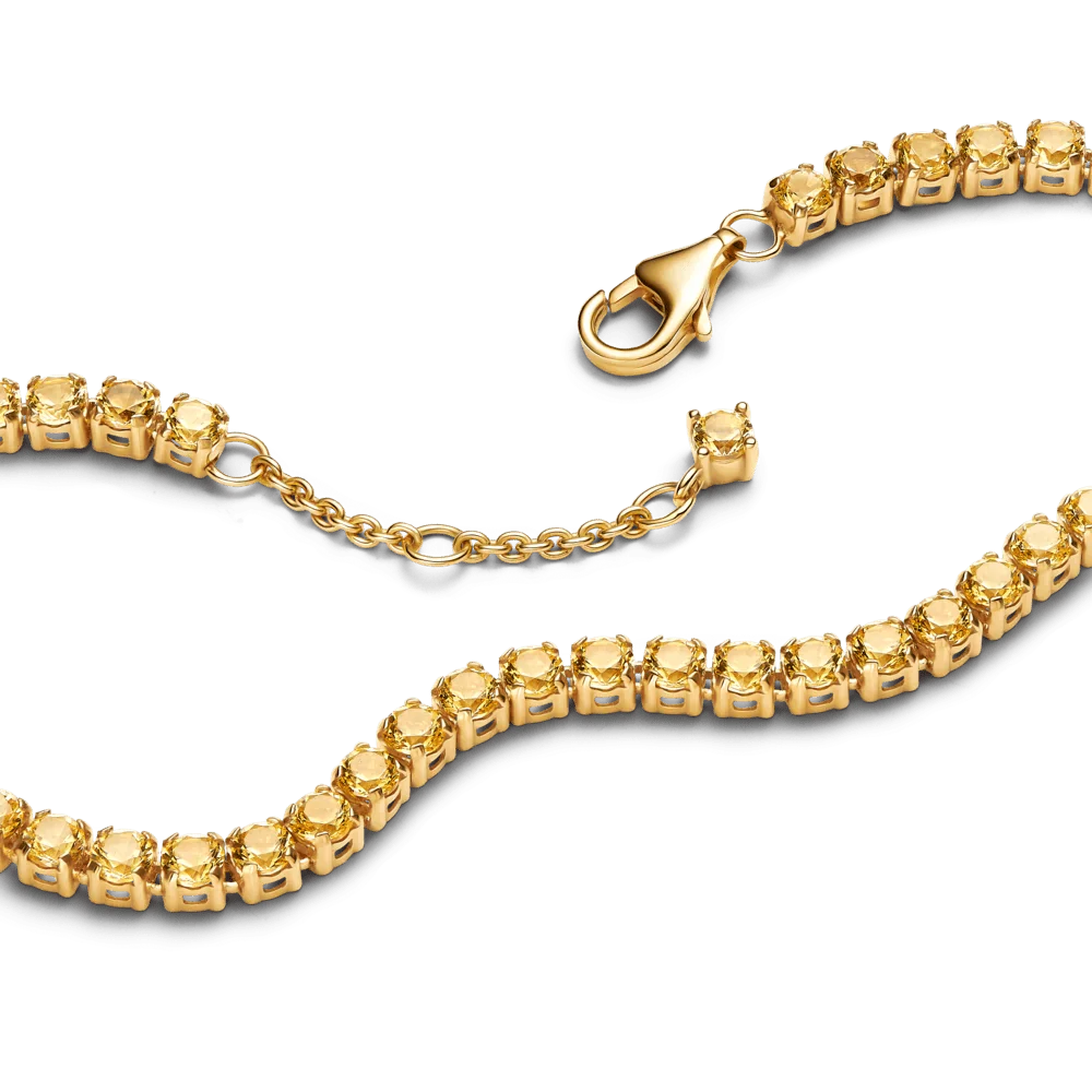 Spīdīga dzeltena tenisa rokassprādze